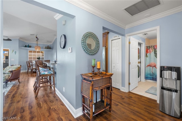 hall with dark wood-type flooring and ornamental molding