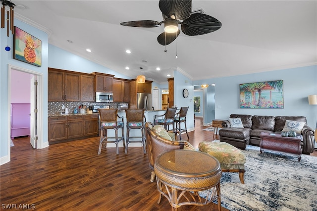 living room featuring dark hardwood / wood-style floors, ceiling fan, lofted ceiling, and ornamental molding