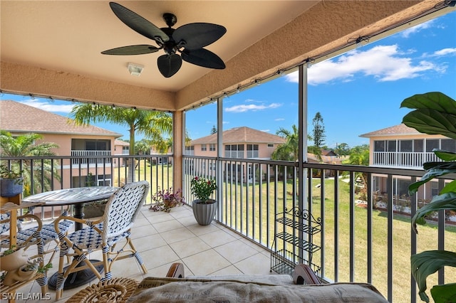 sunroom / solarium featuring ceiling fan