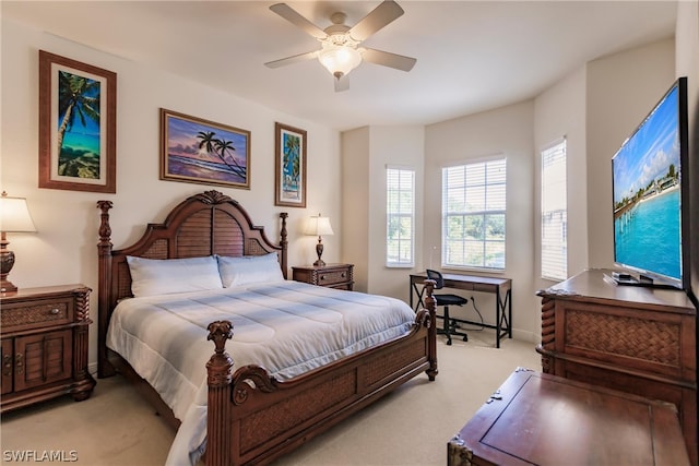 bedroom featuring light carpet, ceiling fan, and baseboards