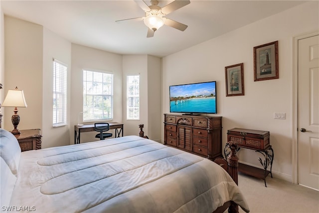 bedroom featuring a ceiling fan, light carpet, and baseboards