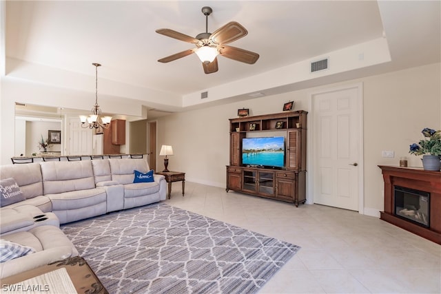 living area with baseboards, visible vents, a raised ceiling, and light tile patterned flooring