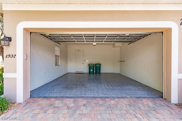 garage featuring decorative driveway