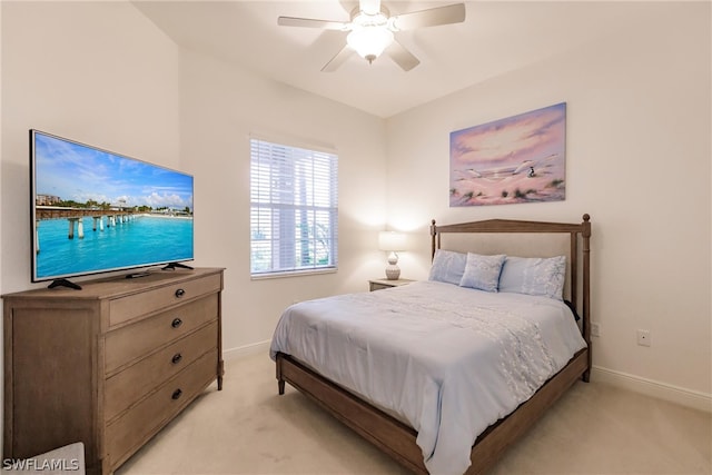 bedroom with ceiling fan, baseboards, and light colored carpet