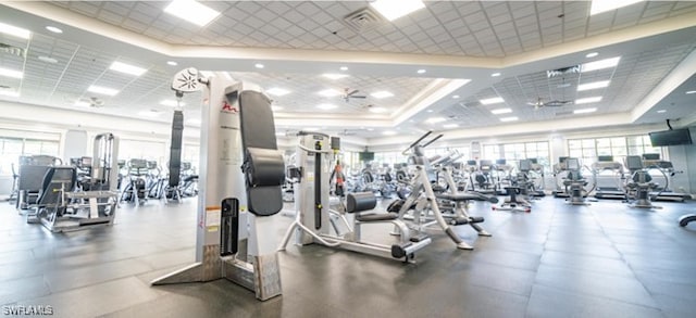 gym featuring a raised ceiling and visible vents