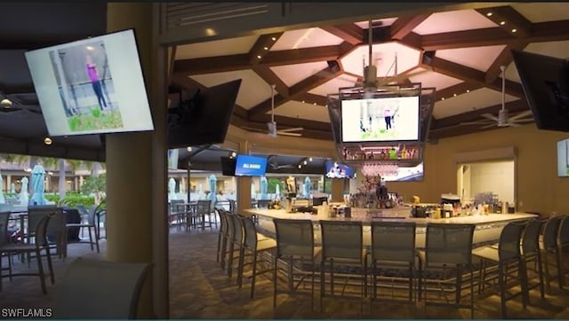 bar with a community bar and ceiling fan