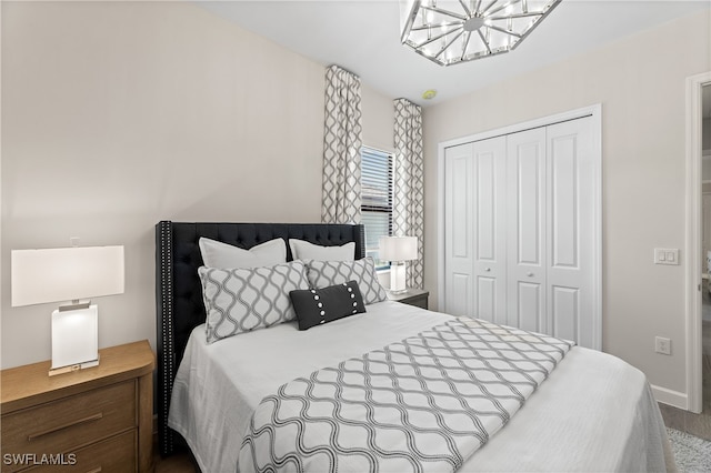 bedroom featuring a closet and an inviting chandelier