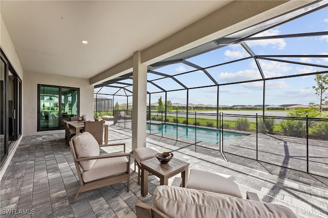 view of patio / terrace with a lanai, outdoor lounge area, and an outdoor pool