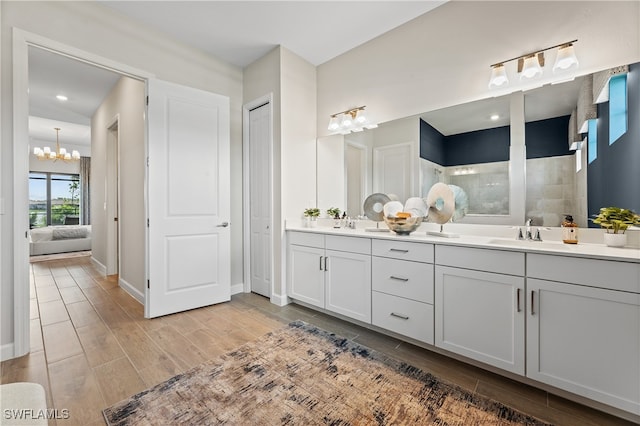 bathroom with double sink vanity and a chandelier