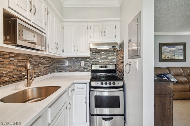 kitchen featuring white cabinets, appliances with stainless steel finishes, crown molding, and sink