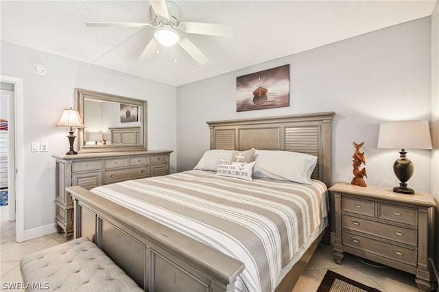 tiled bedroom with ceiling fan and a textured ceiling