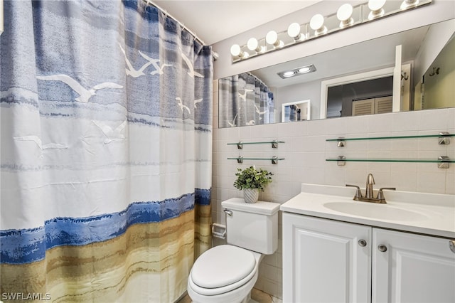 bathroom featuring vanity, toilet, tile walls, and walk in shower