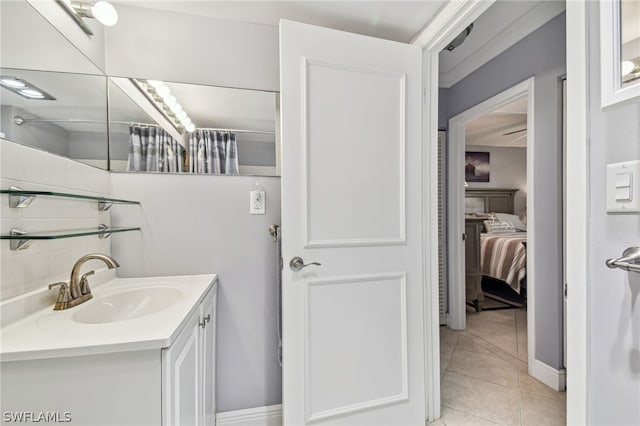 bathroom with tile patterned floors, tasteful backsplash, and vanity