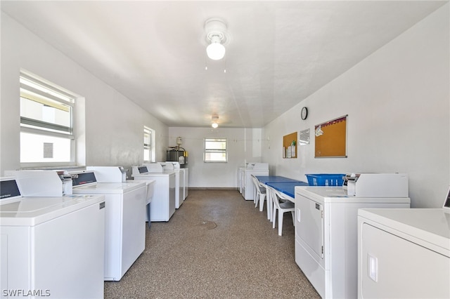 clothes washing area with a healthy amount of sunlight and independent washer and dryer