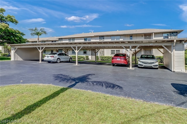 exterior space with a carport and a lawn