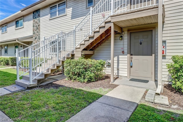 entrance to property with a lawn