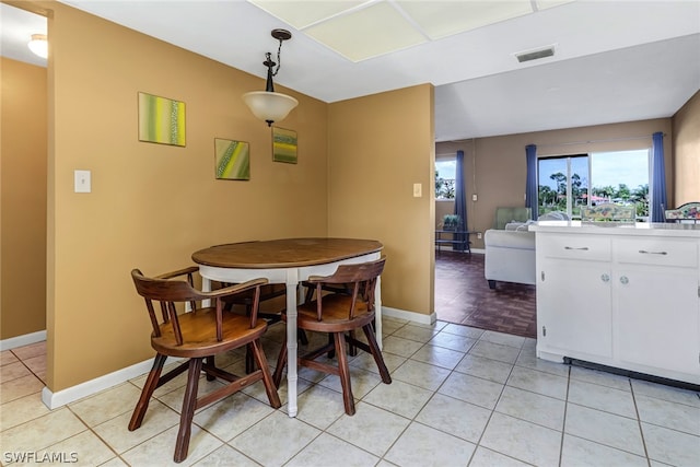 dining space featuring light tile flooring