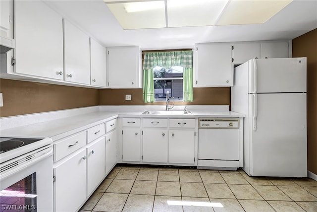 kitchen with white cabinets, sink, white appliances, and light tile floors