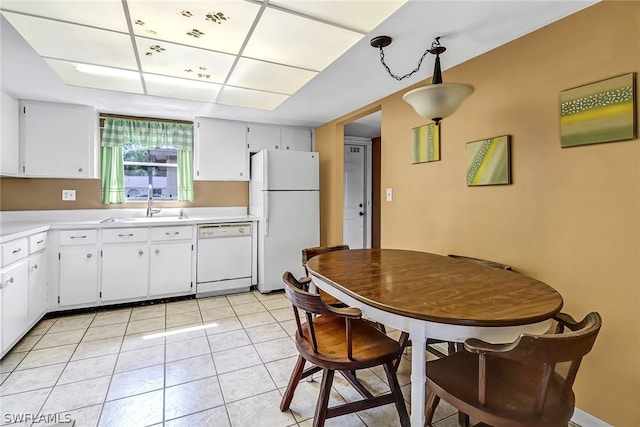 kitchen with white appliances, sink, light tile floors, and white cabinetry