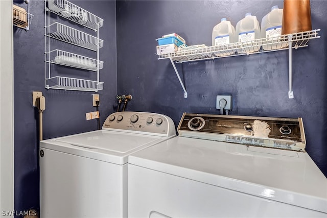 clothes washing area featuring electric dryer hookup, hookup for a washing machine, and separate washer and dryer