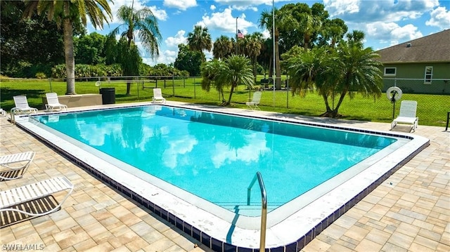 view of swimming pool with a patio and a lawn