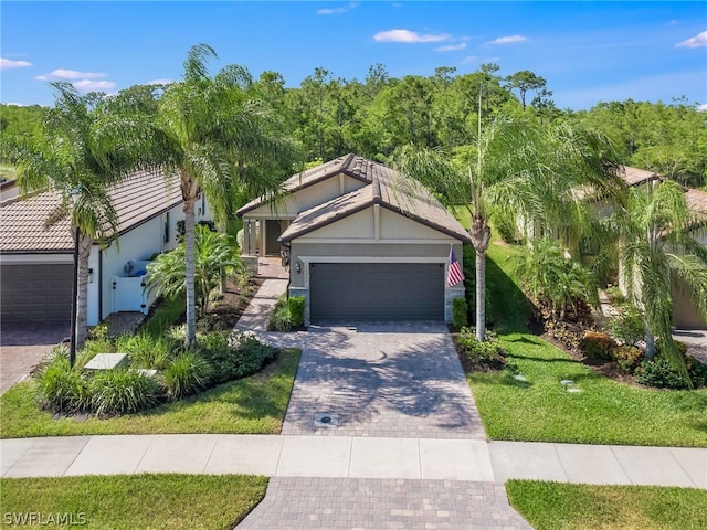 view of front of property featuring a garage and a front lawn