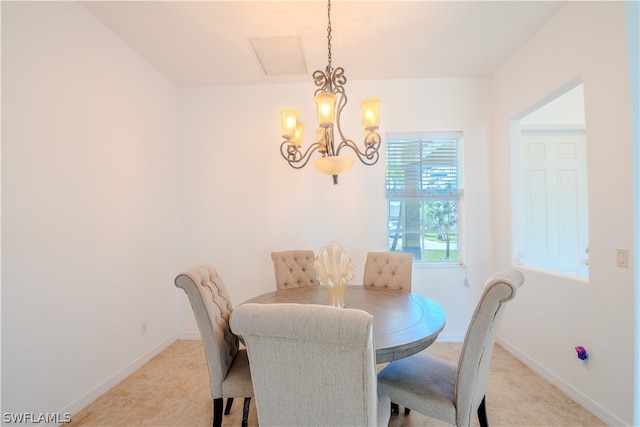 dining room featuring tile flooring and an inviting chandelier