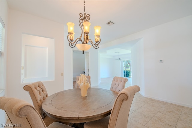 dining area with a notable chandelier and light tile floors