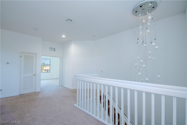 hallway with light colored carpet