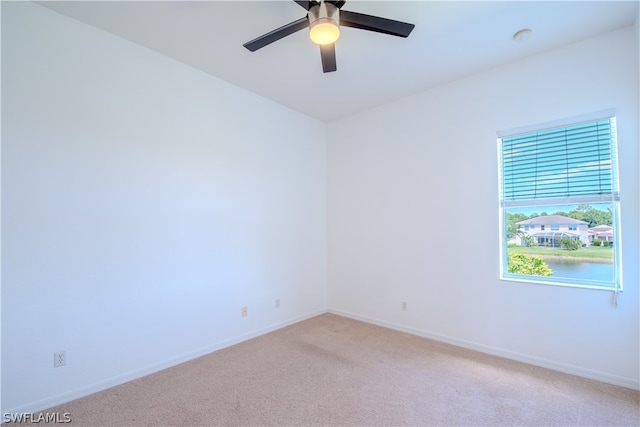 spare room with ceiling fan and carpet floors