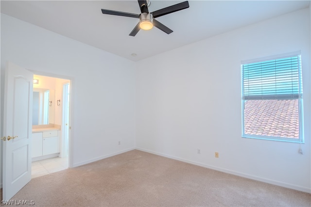 spare room with ceiling fan and light carpet