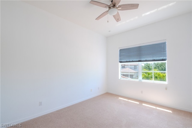 spare room featuring ceiling fan and carpet floors