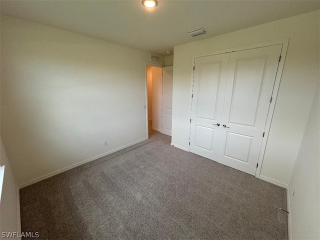 unfurnished bedroom with a closet and carpet floors