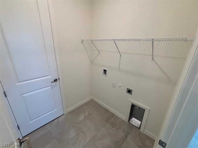 washroom featuring hookup for an electric dryer, hookup for a washing machine, and tile patterned floors