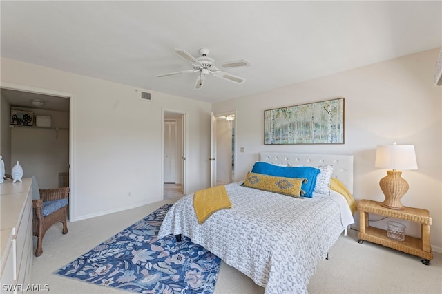 carpeted bedroom with ceiling fan and a closet