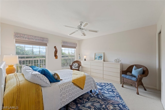 carpeted bedroom featuring access to exterior and ceiling fan