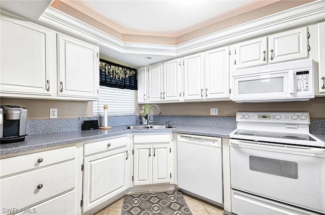 kitchen featuring sink, white appliances, white cabinetry, and light tile floors