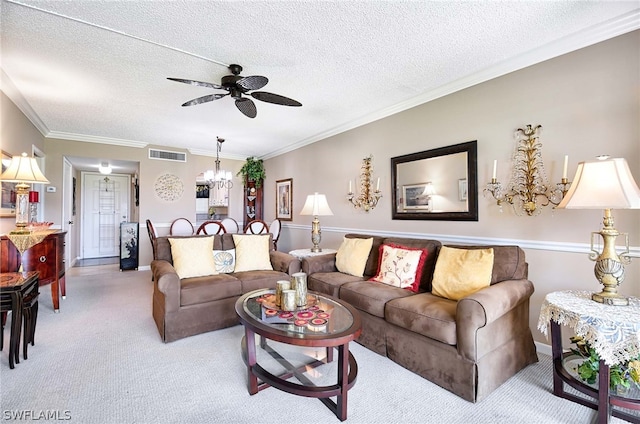 living room featuring ceiling fan with notable chandelier, carpet flooring, a textured ceiling, and ornamental molding