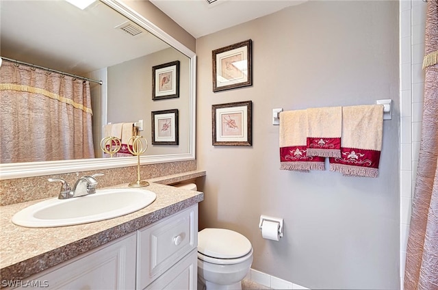 bathroom featuring tile floors, toilet, and oversized vanity