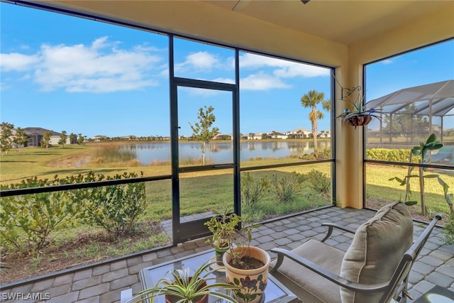 sunroom / solarium with a water view