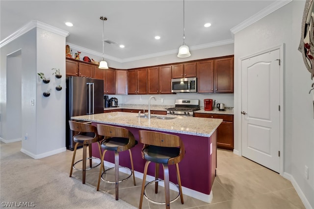 kitchen with sink, light stone countertops, an island with sink, stainless steel appliances, and pendant lighting