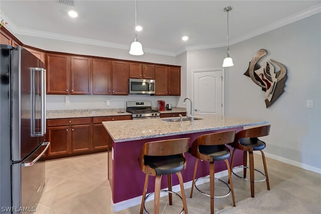 kitchen featuring pendant lighting, appliances with stainless steel finishes, light stone counters, light tile patterned floors, and sink