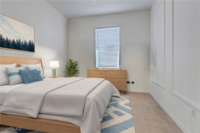 bedroom featuring light carpet