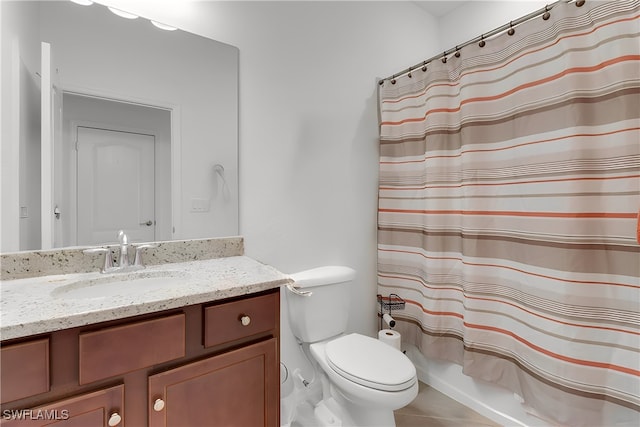 bathroom featuring tile patterned flooring, toilet, and vanity