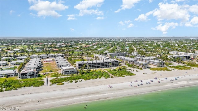 birds eye view of property with a water view and a beach view