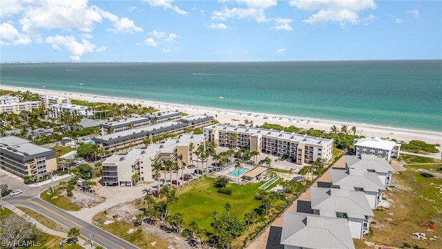 drone / aerial view featuring a water view and a beach view