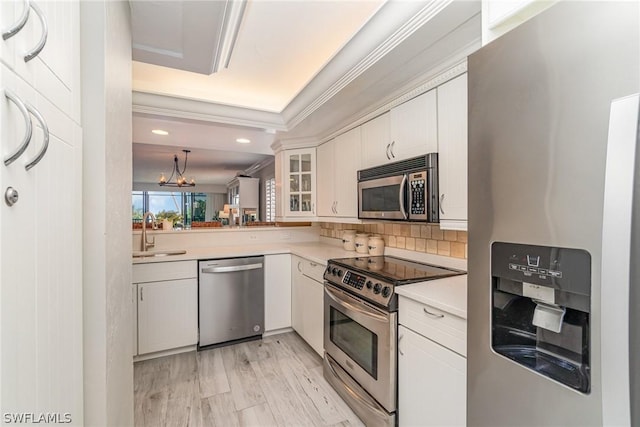 kitchen with white cabinets, stainless steel appliances, light hardwood / wood-style flooring, and sink