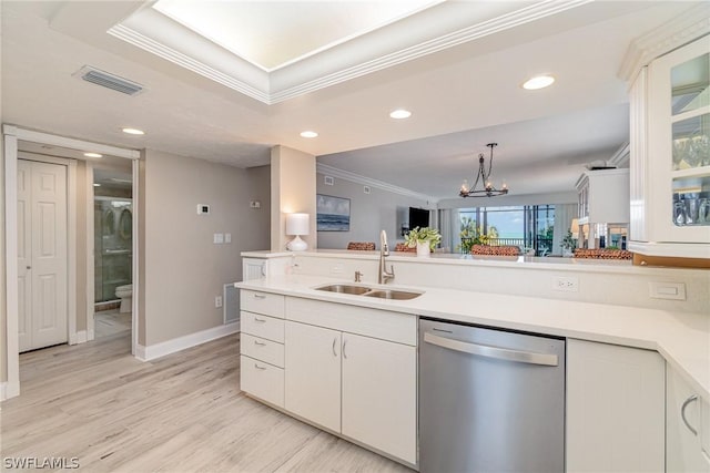 kitchen with dishwasher, white cabinets, an inviting chandelier, and sink