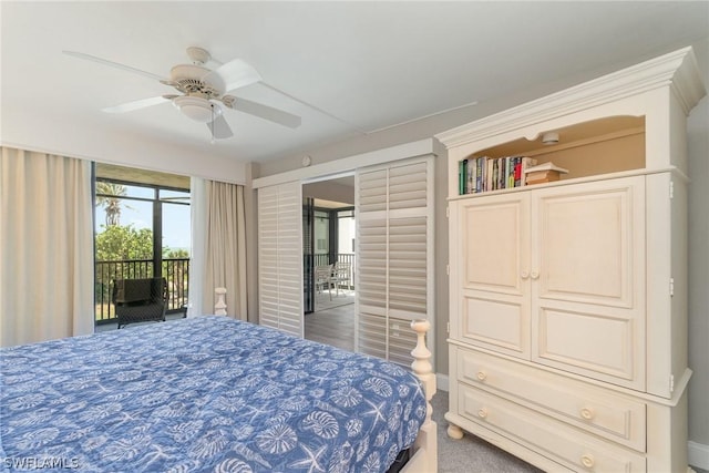 bedroom featuring access to outside, ceiling fan, and dark colored carpet