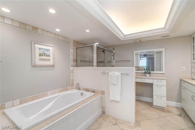 bathroom with vanity, a raised ceiling, crown molding, ceiling fan, and shower with separate bathtub